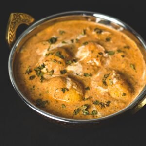 Flavorful dum aloo curry served in a traditional kadai, perfect for Indian cuisine lovers.