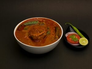 Delicious spicy mutton curry with vegetables, garnished with spices. Perfect for Indian cuisine lovers.
