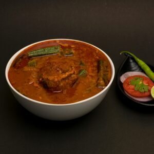 Delicious spicy mutton curry with vegetables, garnished with spices. Perfect for Indian cuisine lovers.