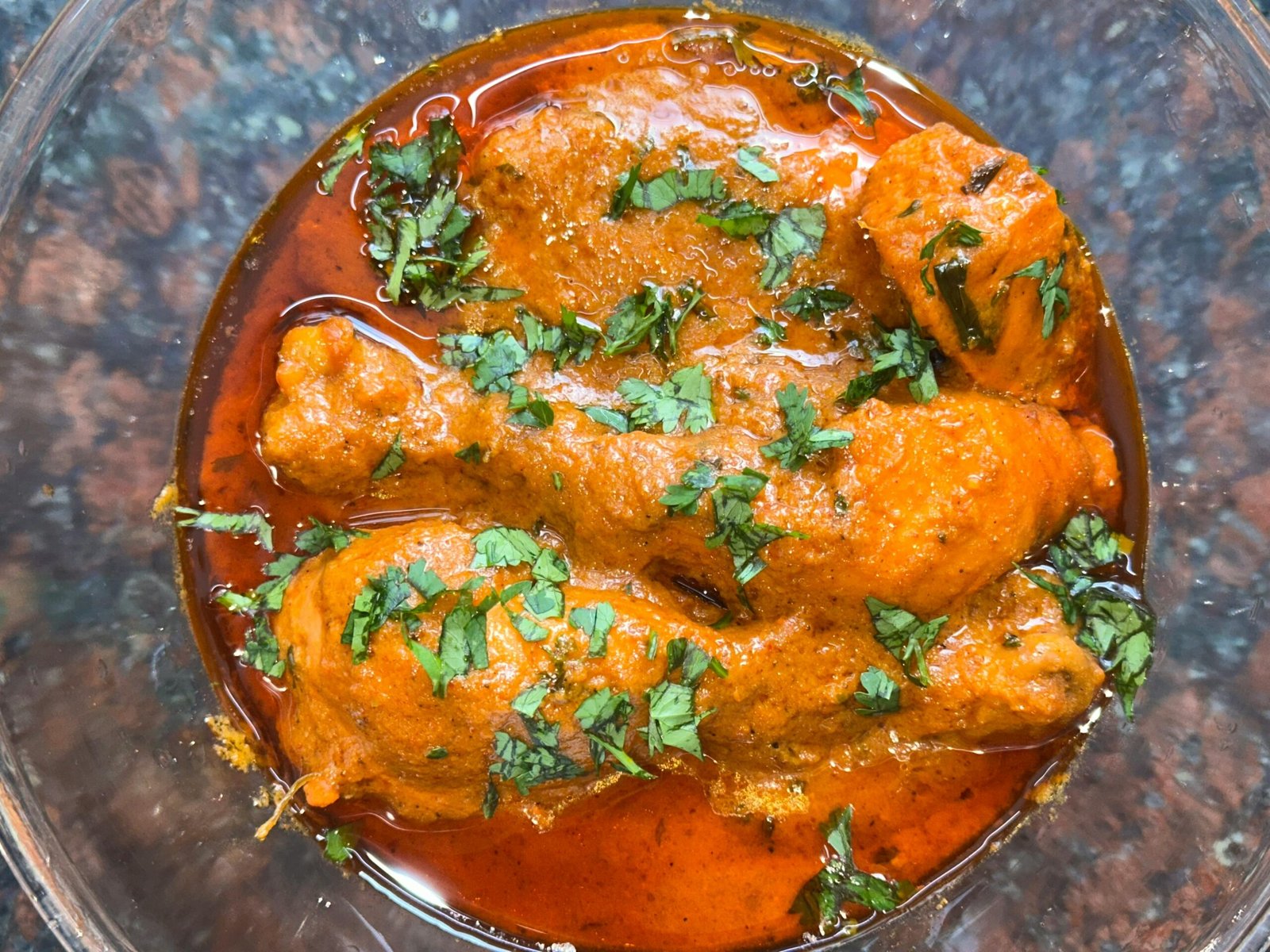 pexels-photo-36264075-36264075 Close-up of a spicy chicken curry dish topped with fresh cilantro, perfect for Indian cuisine enthusiasts.