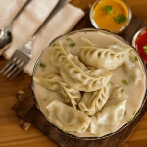 Nepalese Jhol Momo served in savory broth with vibrant sauces. A culinary treat from Itahari.