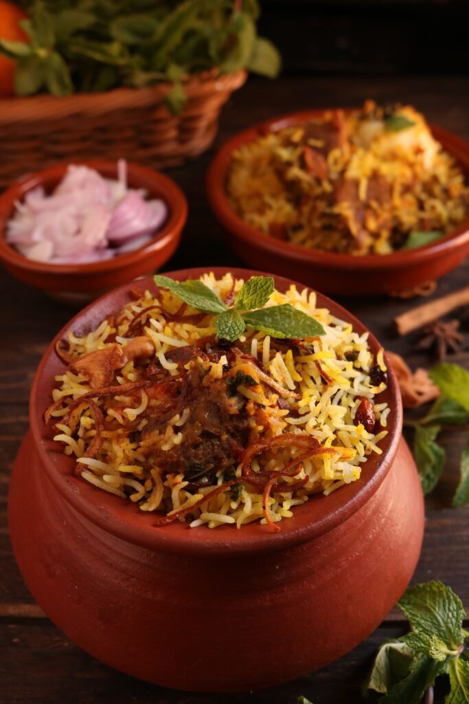 HYDRABADI BIRYANI Delicious biryani served in a clay pot with garnishes, showcasing traditional Indian flavors.